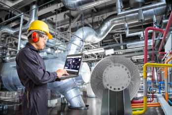 plant operator using a hand-held two way radio.