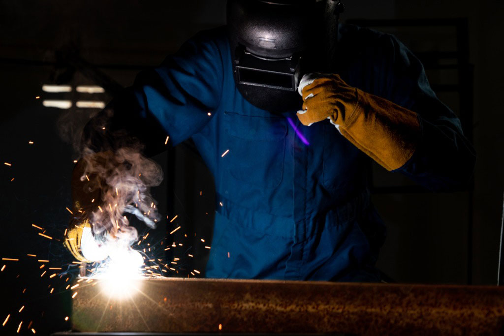 welder fixing a pipe