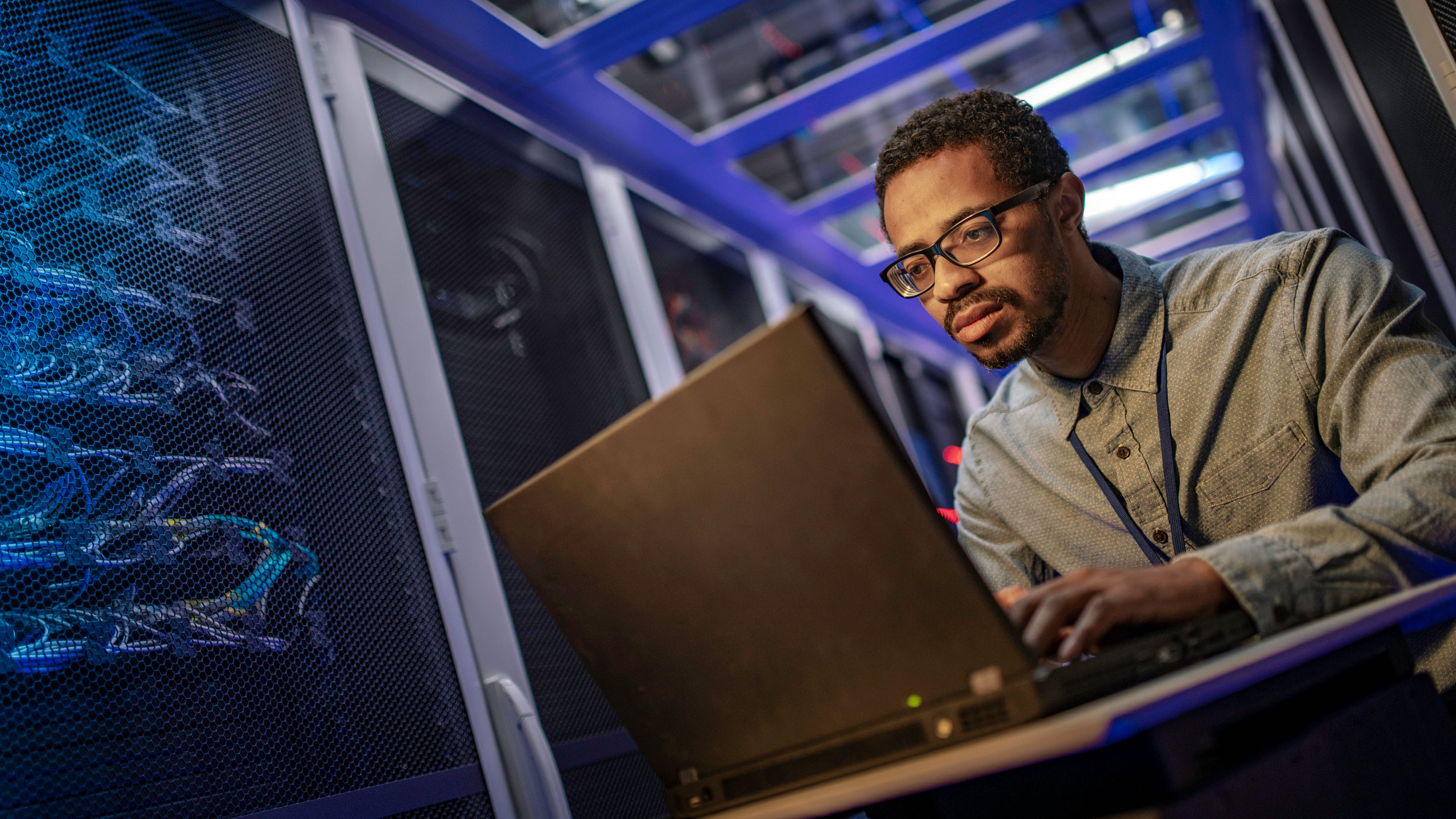 cyber security technician working on a laptop