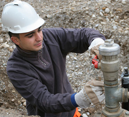 natural gas technician fixing a pipe